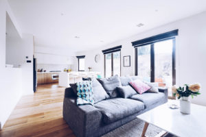 Open plan living room kitchen contemporary home with grey sofa